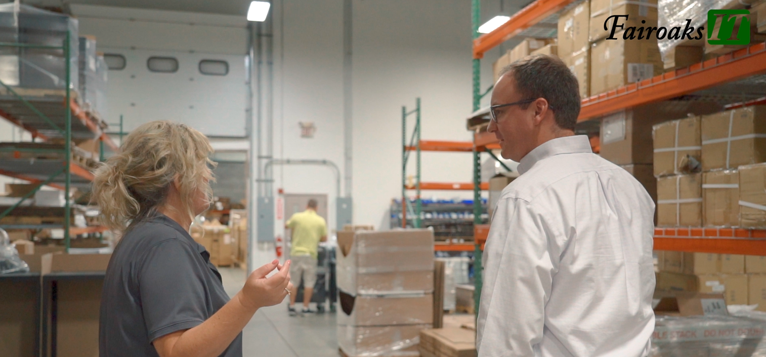 A man and a woman walking through a warehouse